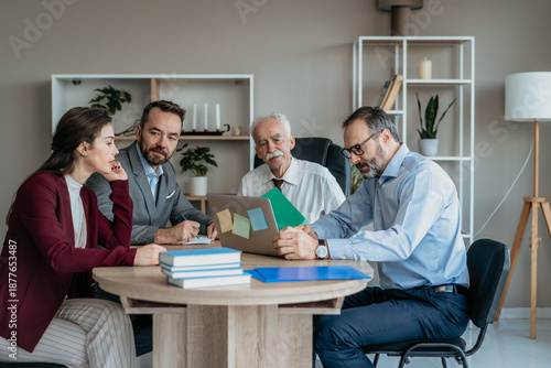 Multi-Generational Business Team Showing Work to Senior Executive in Modern Office – Mixed Generations