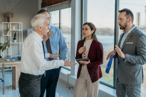 Multi-Generational Business Team Discussing Problem in Modern Office – Business Conflict