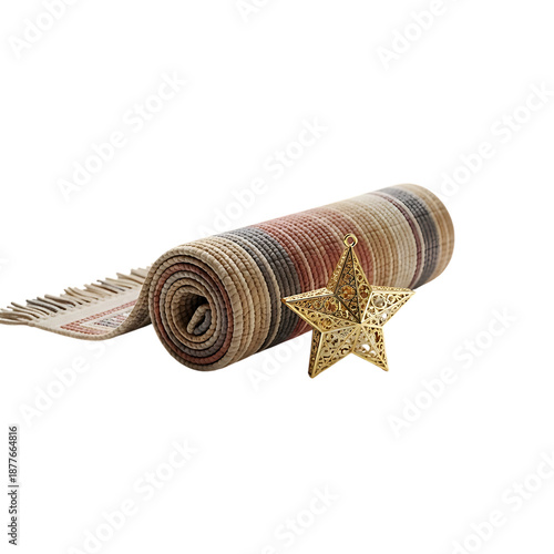 Rolled up woven mat textile next to an intricate golden metal star ornament