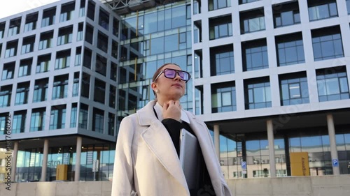 Wallpaper Mural Young student walking near office building thinking about future career dreaming of first job and new opportunities calm city evening steps and hopes Torontodigital.ca