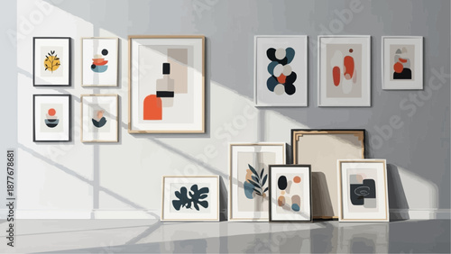 A collection of abstract art pieces displayed on a gray wall and floor