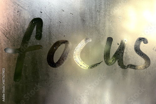 The word FOCUS written on misted glass