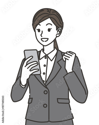 スマホを見て喜ぶスーツ姿の女性