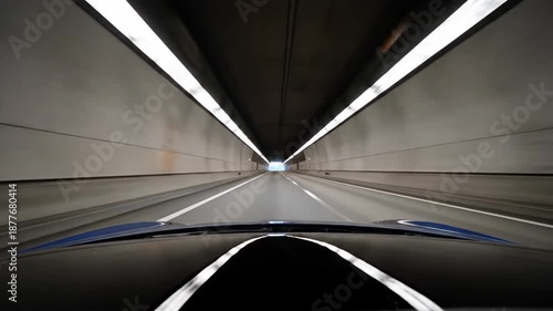 Wallpaper Mural A car is driving through a tunnel with white lights in the ceiling, the light at the end Torontodigital.ca