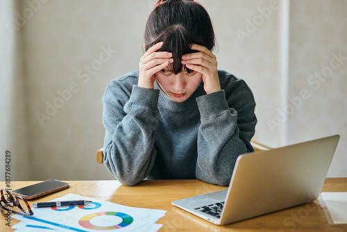 Bilde på lerret Stressed Businesswoman Suffering from Headache While Working on Laptop at Desk