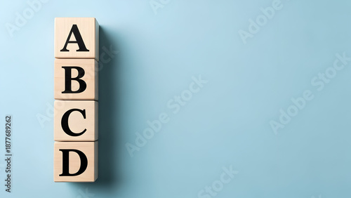 Captivating stock photo displaying four wooden blocks, each adorned with a letter, creatively arranged on a vibrant blue backdrop for commercial use now.