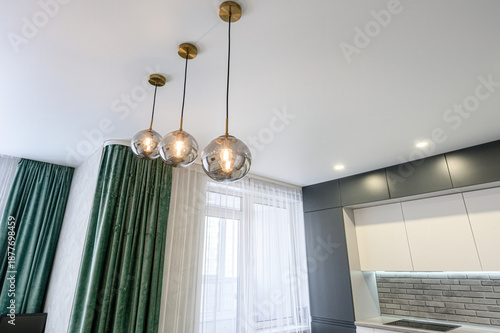 Photography modern kitchen with sleek grey cabinetry, grey brick-style backsplash, three sph