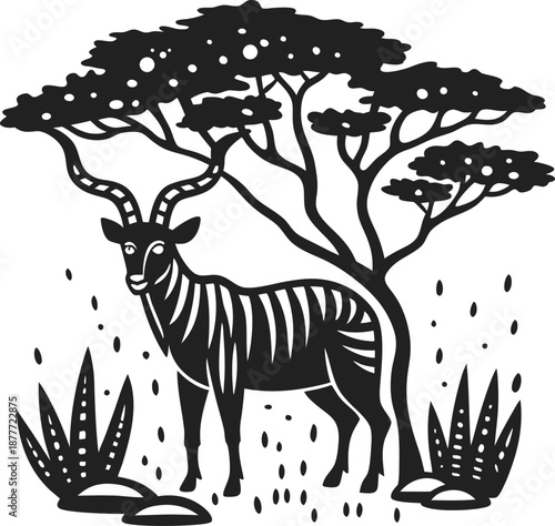 Antelope with striped body standing under broad tree amidst bushes and rocks in savanna landscape