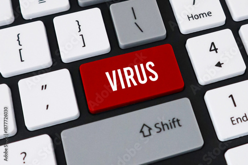 Red virus button on computer keyboard. Concept of cyber security threat, malicious software and digital attack.