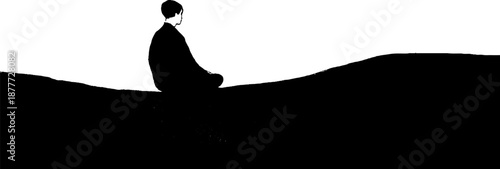 Silhouette of a person meditating on a hilltop