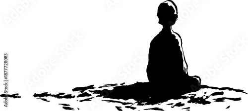 Silhouette of a young child meditating alone in peaceful setting