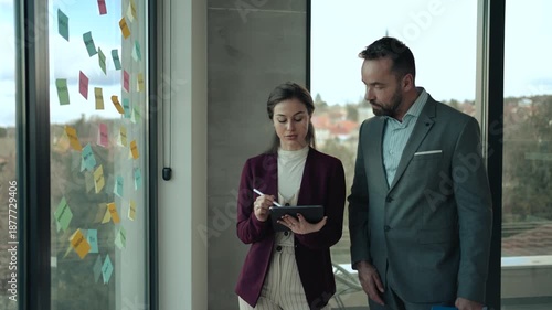 Middle-Aged Man and Young Woman Working in Modern Office with Sticky Notes – HR and Creative Concept