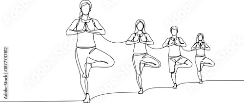 Group of people practicing yoga together in tree pose