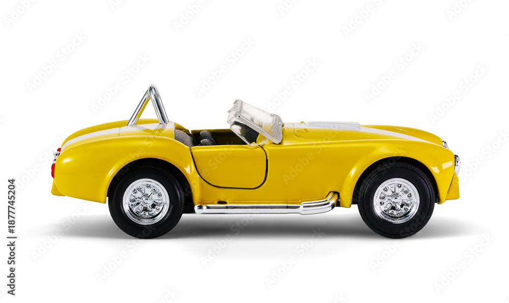 Obraz premium Miniature yellow toy racing car on white background