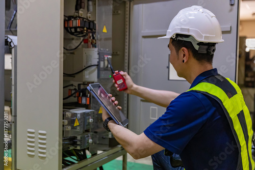 Inspector examination of photovoltaic modules using a thermal imaging camera. Engineer Checking Temperature the string cables input to inverter solar panel used thermos infrared.