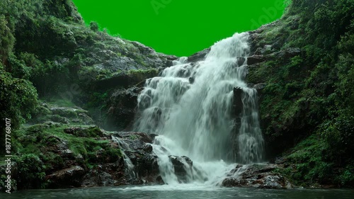 A large waterfall cascading down a rocky slope surrounded by lush greenery and vegetation