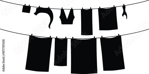 Silhouette of wet laundry hanging on a clothesline to dry, domestic household chore concept, clean clothes and linens in sun