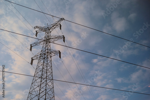 Transmission tower standing against a blue sky with scattered clouds. Chengdu, Sichuan, China