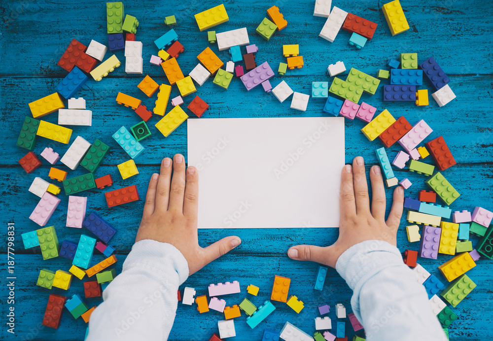 Fototapeta premium Сolourful creative children's background with colored toy bricks