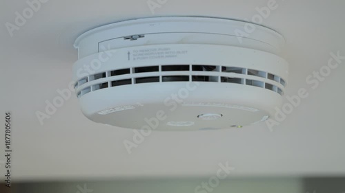 4K: Testing a smoke alarm in a house. A man uses his finger to push the button. Stock Video Clip Footage.