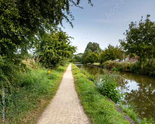 Footpath or traditional towpath next to canal in Cheshire UK