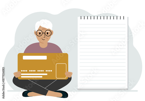 A man sits cross-legged in his hands holding a large credit card next to a close-up notepad for text. Concept of credit card, expense planning, income planning.