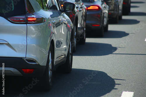 Heavy traffic congestion on highway with cars, tunnels, and traffic signals.