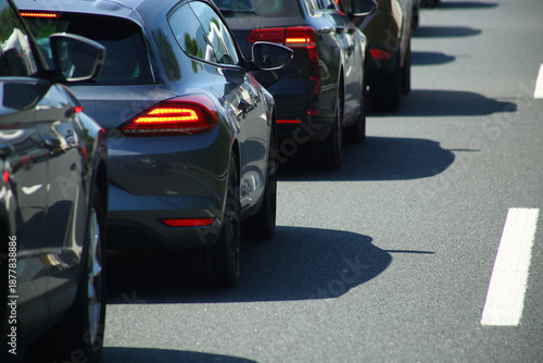 Heavy traffic congestion on highway with cars, tunnels, and traffic signals.