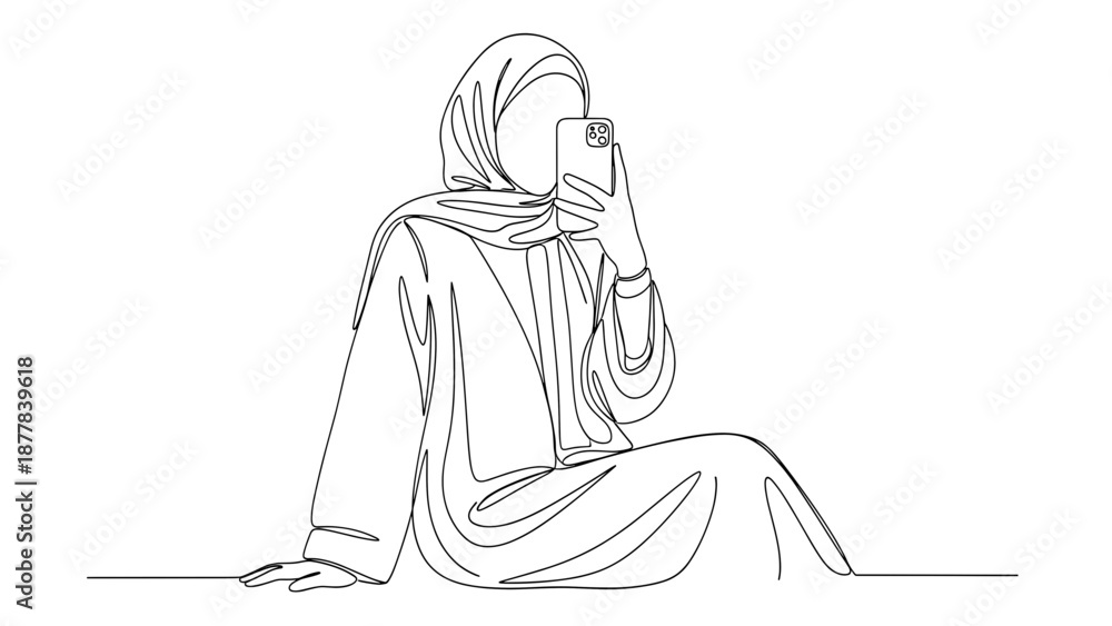 Obraz premium Woman in hijab sitting with smartphone