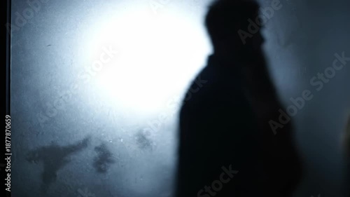 Wallpaper Mural Silhouettes of a Man and Woman Separated by Conflict, Seen Through Frosted Glass: Dramatic Abstract Scene Representing Relationship Crisis, Isolation, Fear, or Domestic Issues. Torontodigital.ca