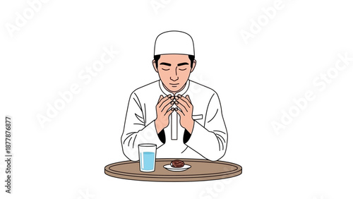 Man in traditional attire praying before meal with water and date