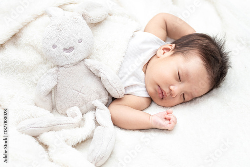 Wallpaper Mural Top view of a baby sleeping on a bed. With a white doll rabbit. Beautiful portrait of a small asian baby. A cute little newborn baby in a blanket. Torontodigital.ca