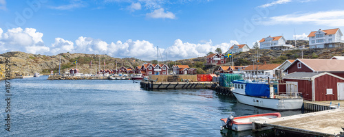 Tableau sur toile Harbor scene island Stora Dyron in Sweden, with red houses, flags, and moored bo