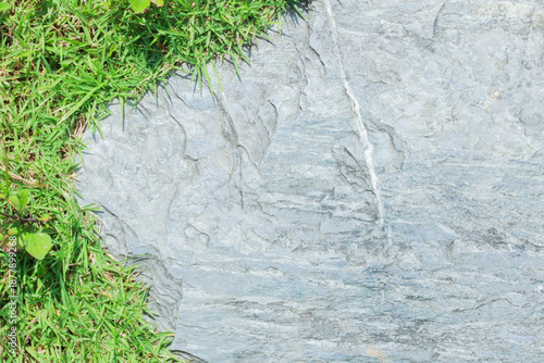 Close-up view of granite laid on grass lawn, creating a natural