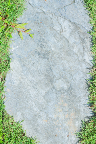 Close-up view of granite laid on grass lawn, creating a natural