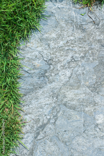 Close-up view of granite laid on grass lawn, creating a natural