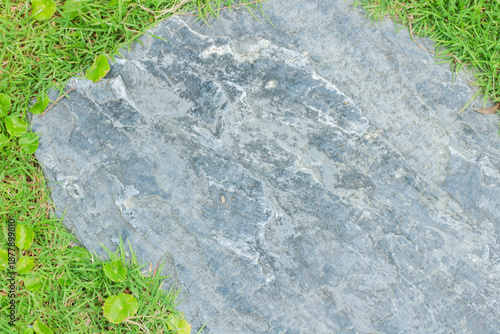 Close-up view of granite laid on grass lawn, creating a natural
