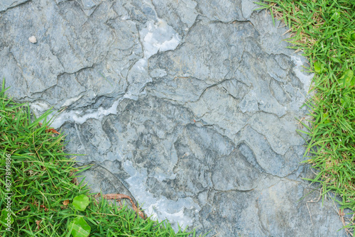 Close-up view of granite laid on grass lawn, creating a natural