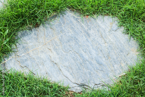 Close-up view of granite laid on grass lawn, creating a natural
