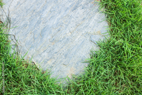 Close-up view of granite laid on grass lawn, creating a natural