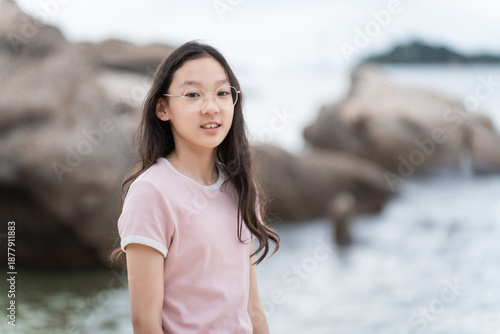 Girl wearing glasses gazing at the beach