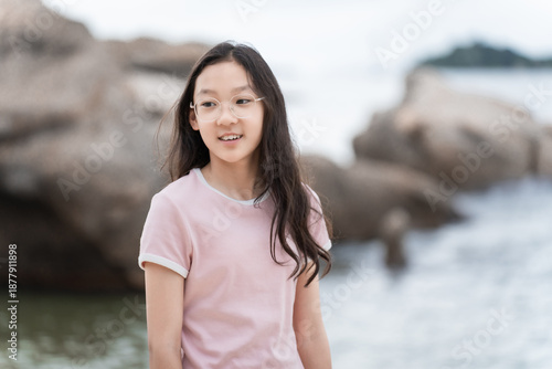 Girl wearing glasses gazing at the beach