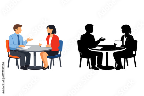 Two people sitting at a table, discussing documents