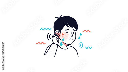 Concerned young boy touching his red and painful ear while suffering from a common middle ear infection or hearing discomfort symptoms.