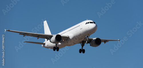 The plane lands.Airplane, passengers flying in the blue sky, preparing to land at the airport	