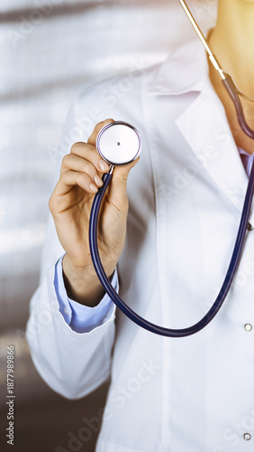 Close-up of doctor holding stethoscope in modern medical office