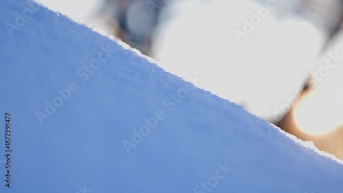 Abstract winter footage of a snow ridge in soft focus with bright bokeh background, clean minimal composition for seasonal backgrounds and design overlays.