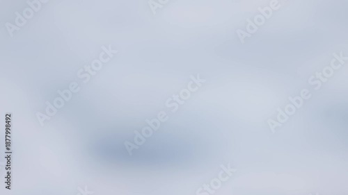 Defocused winter background footage with soft blue-grey tones and gentle blur, clean minimalist backdrop for titles, transitions, and atmospheric overlays.