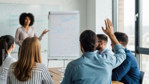 Engaged students raising hands in a modern classroom setting