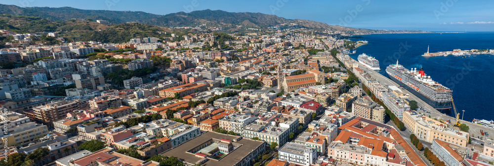 Fototapeta premium Aerial panoramic view of the historic center of Messina, Sicily, Italy. It is a coastal city overlooking the Mediterranean Sea. At the center of the city is the Metropolitan Cathedral Basilica.